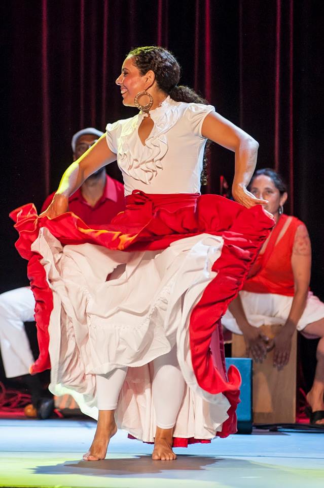 Monica Rojas-Stewart dances in a red skirt 