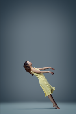 Dancer in a yellow dress falls backwards. 