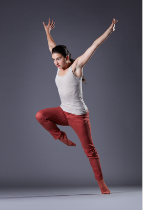 Lucy falls forward with her right leg in passé and her arms wide behind her. 