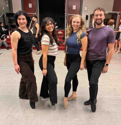 UW alumni smiling in rehearsal room