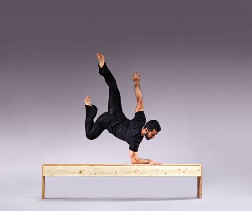 Wilson balances on his forearm on a bench defying gravity 