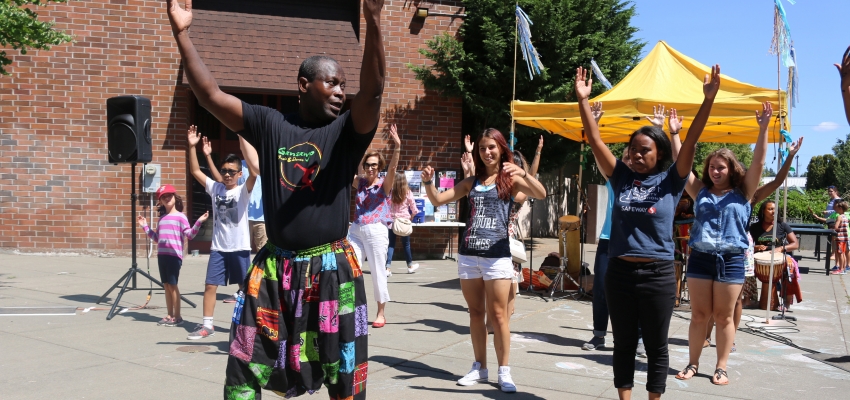 Etienne teaching a West African dance class outside 
