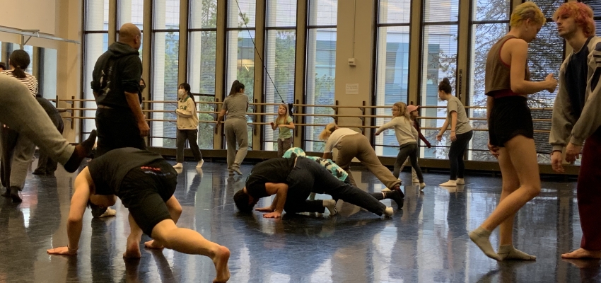 elementary students and UW students practice Capoeira together 