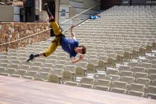 Roel Seeber hangs sideways from the ceiling in a harness.