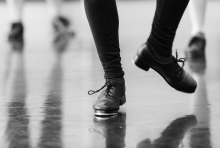 Image contains dancing feet in tap shoes. 