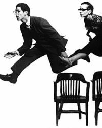 Shapiro and smith leaping over chairs 