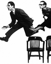 Shapiro and smith leaping over chairs 