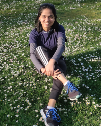 Sweekruthi sitting in a field