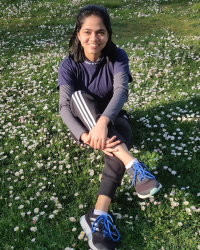 Sweekruthi sitting in a field 