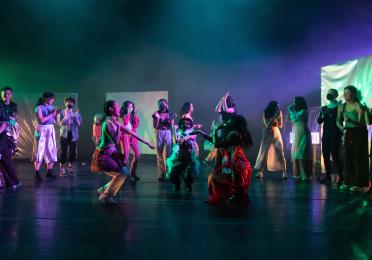 Dancers is brightly colored outfits 