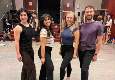 UW alumni smiling in rehearsal room