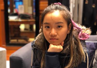 Natalie Yap rests their chin on their fist
