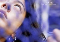 woman peaking through purple link fence