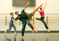 Dances leaping and tumbling over and around each other in the studio 
