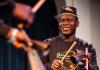 Etienne Cakpo plays percussion and smiles