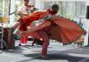 Etienne Cakpo dancing in a wide orange dress 