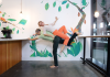 Juliet balances laying on top of Cristian who is tilted and standing on one leg 