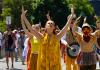 Juliet McMains leading procession with raised arms 