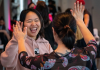 Dancers gleefully high-fiving each other.