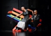 two dancers sit on a slanted bench 