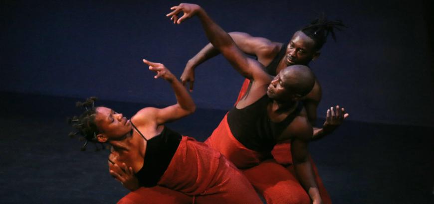 Etienne dancing with 2 others in red pants