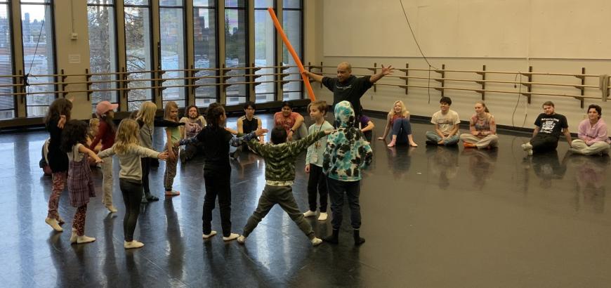 Mestre Silvinho teaches the elementary students capoeira with a pool noodle