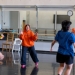 Annie Franklin teaching dance class wearing a bright orange hoodie. 