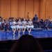 Four dancers performing "dance of the little swans" in front of the orchestra on Meany Hall stage 