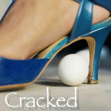 white egg under high-heeled shoe