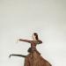 Erin in brown dress lunging with arm out 